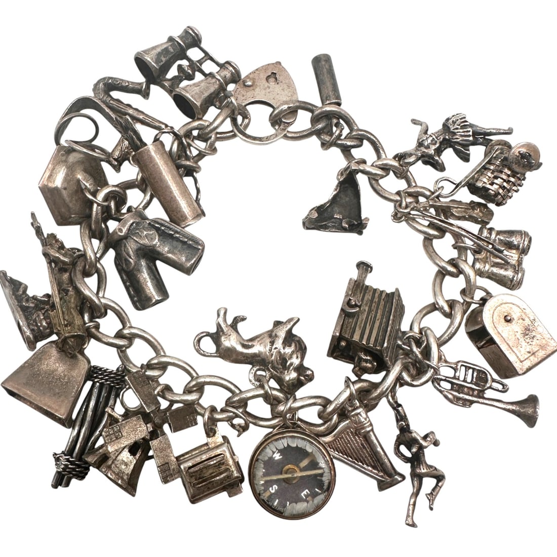 Vintage Silver Charm Bracelet: Bracelet measures 7" long. Most charms are sterling. Some are unmarked. Refer to photos for additional condition information as they are a part of the description. Please note lots may show signs of w
