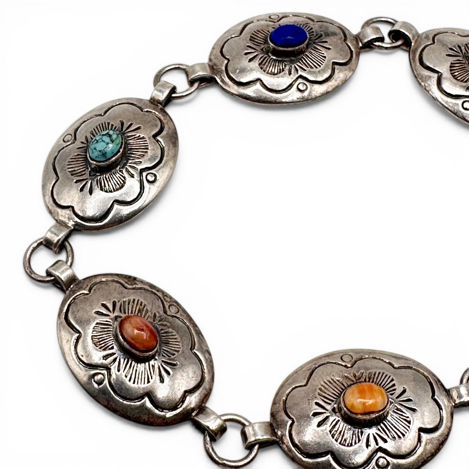 Navajo Sterling Silver Concho Bracelet: Measures 7 1/2" long. Marked 925 on clasp. Refer to photos for additional condition information as they are a part of the description. Please note lots may show signs of wear commensurate with age and