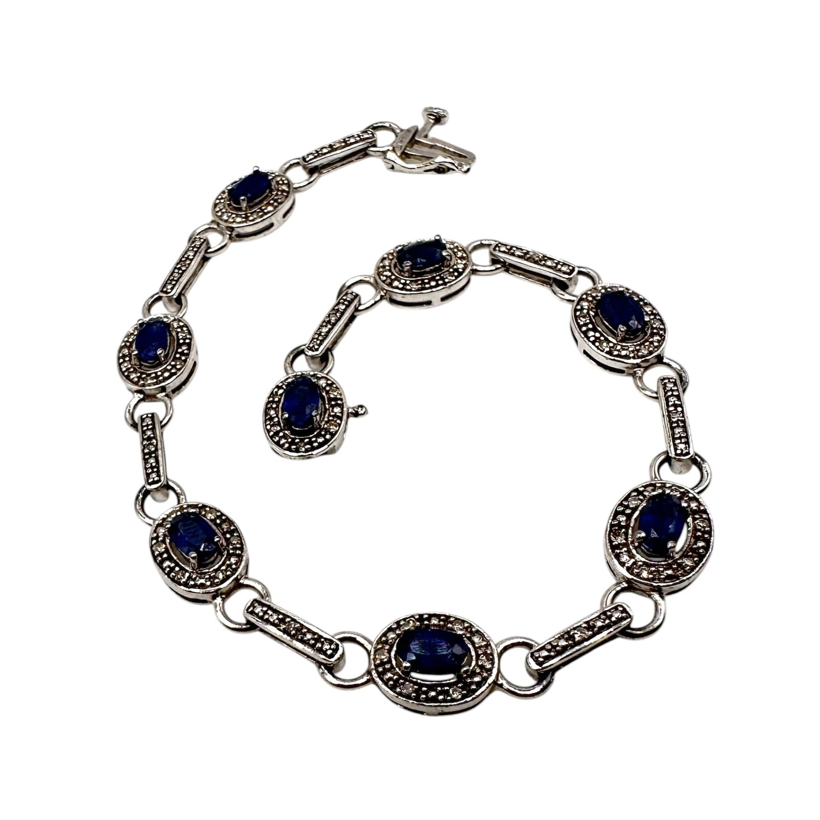 Sterling Silver Sapphire and Diamond Tennis Bracelet: Measures 7" long. Refer to photos for additional condition information as they are a part of the description. Please note lots may show signs of wear commensurate with age and use, and the lack of a s