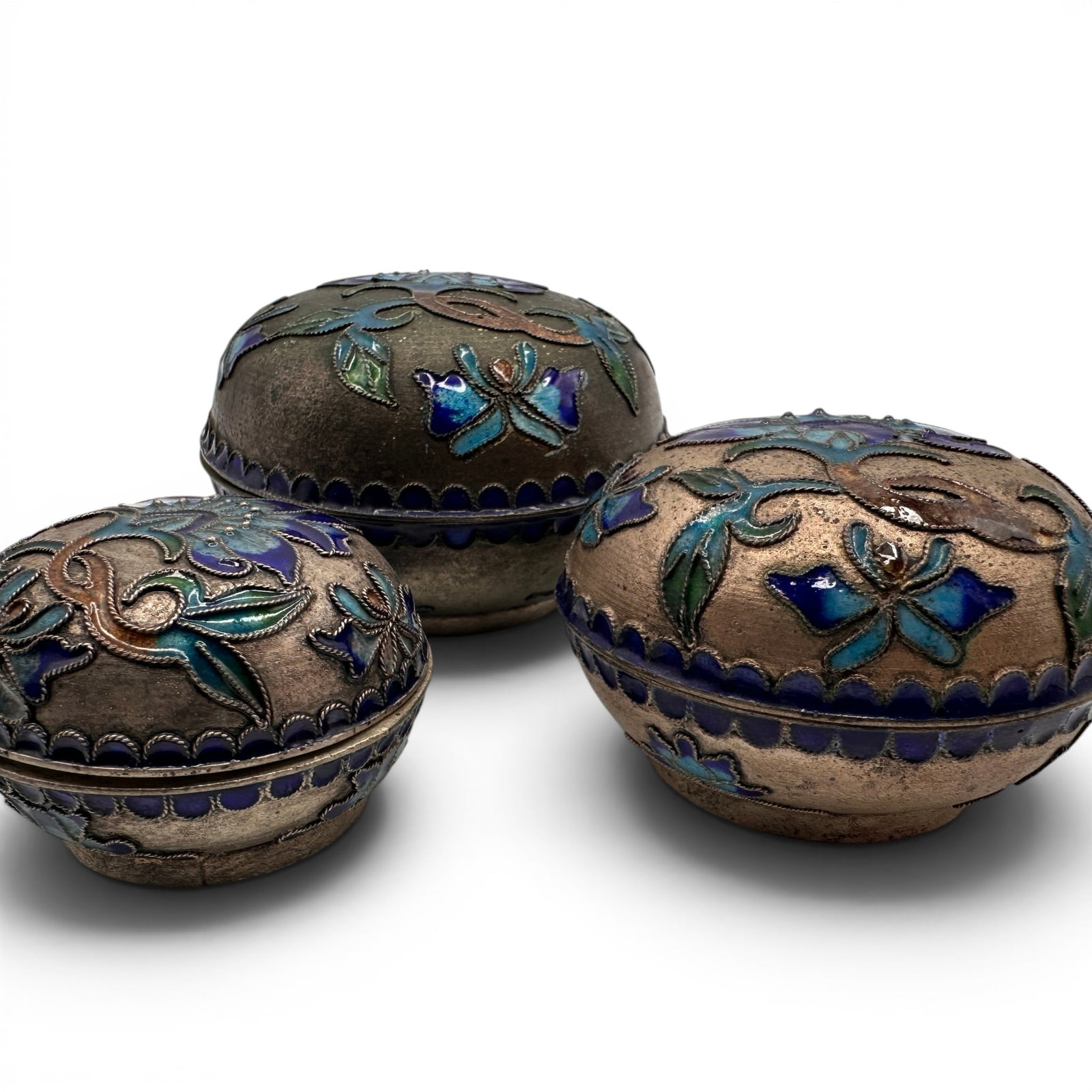 Vintage Enamel Cloisonne Nesting Trinket Boxes: Largest is 3" in diameter. Three boxes total. Refer to photos for additional condition information as they are a part of the description. Please note lots may show signs of wear commensurate with age 