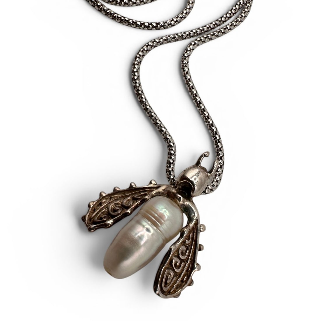 Eve Alfille Freshwater Pearl and Sterling Silver Insect Necklace: Chain measures 18" long. Whimsical and highly collectible Eve Alfille sterling silver necklace featuring the artist's signature nature-inspired design. The pendant is crafted as a stylized insect or b