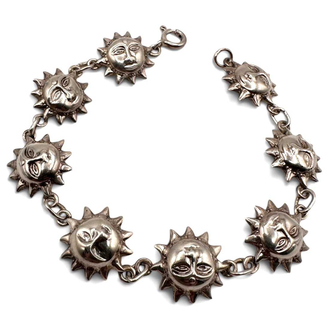 Vintage Sterling Silver Sun Face Bracelet: Measures approximately 7" long. The bracelet is composed of seven sculptural sun charms, connected by sturdy sterling silver links and finished with a secure lobster clasp. Item is being sold as found