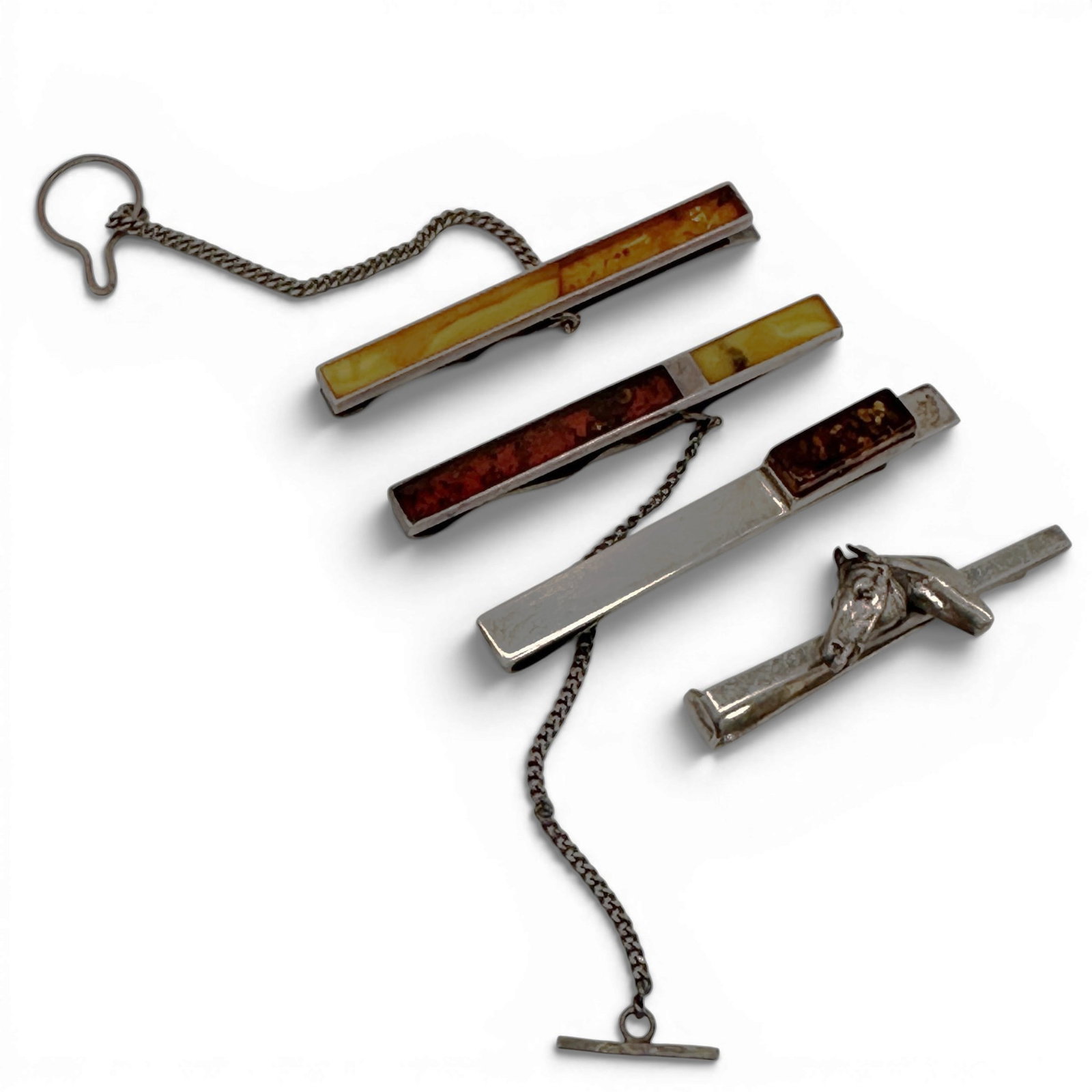 Collection of Sterling Silver and Amber Tie Bars & Horse Head Tie Clip: An attractive collection of four sterling silver gentleman's accessories, including three amber-inlaid tie bars and a sculptural horse head tie clip. This eclectic grouping offers a blend of classic m