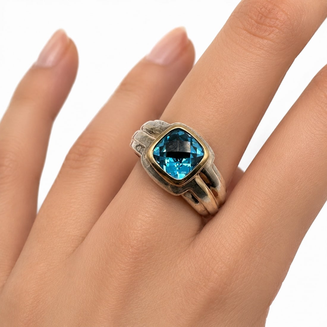 Lorenzo Sterling Silver and 18K Gold Accented Blue Topaz Ring: Ring size 8 1/2. Make a bold statement with this striking Lorenzo sterling silver and blue topaz ring, showcasing the designer's signature blend of contemporary styling and fine craftsmanship. The rin