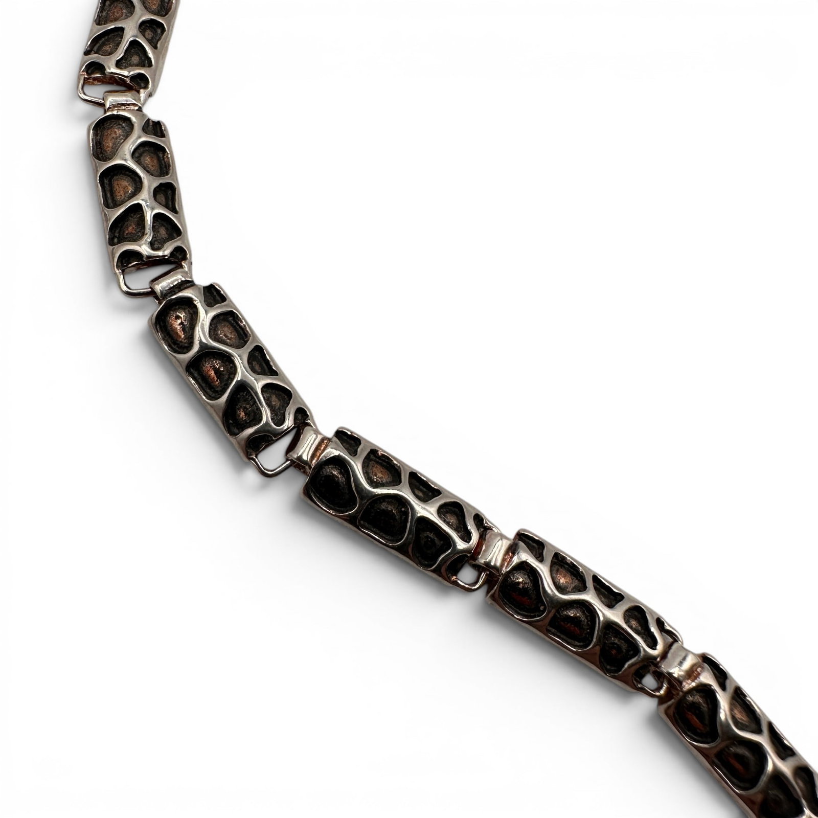 European Organic Patterned Sterling Silver Bracelet: Bracelet measures 7 inches long. A striking example of contemporary Polish silversmithing, this sterling silver bracelet features an elegant design accented by oxidized detailing that creates