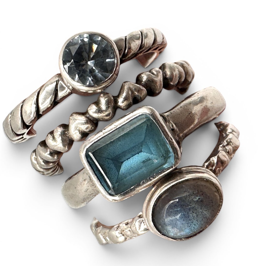 Collection of Pandora, Lori Bonn, and Other Sterling Silver Rings: A stylish assortment of sterling silver gemstone rings featuring a variety of contemporary and artisan-inspired designs. This collection includes four individually crafted rings, each showcasing a uni
