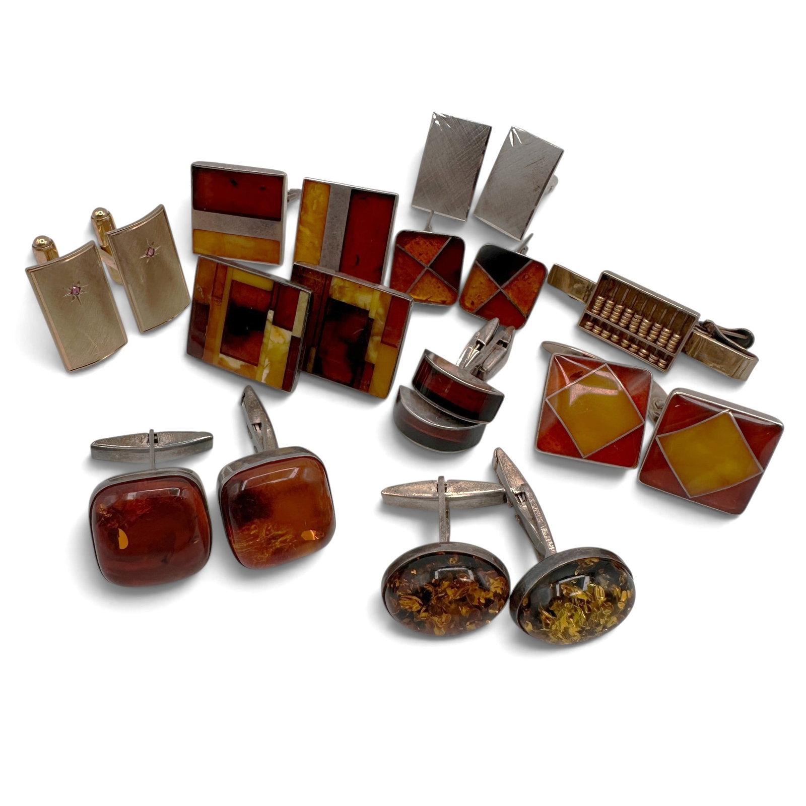 Collection of Vintage Cuff Links & Tie Bars Featuring Amber and Modernist Designs: All are sterling silver with the exception of the gold tone cufflinks. A handsome collection of vintage men's accessories highlighting a variety of cuff link and tie bar designs, many featuring amber 