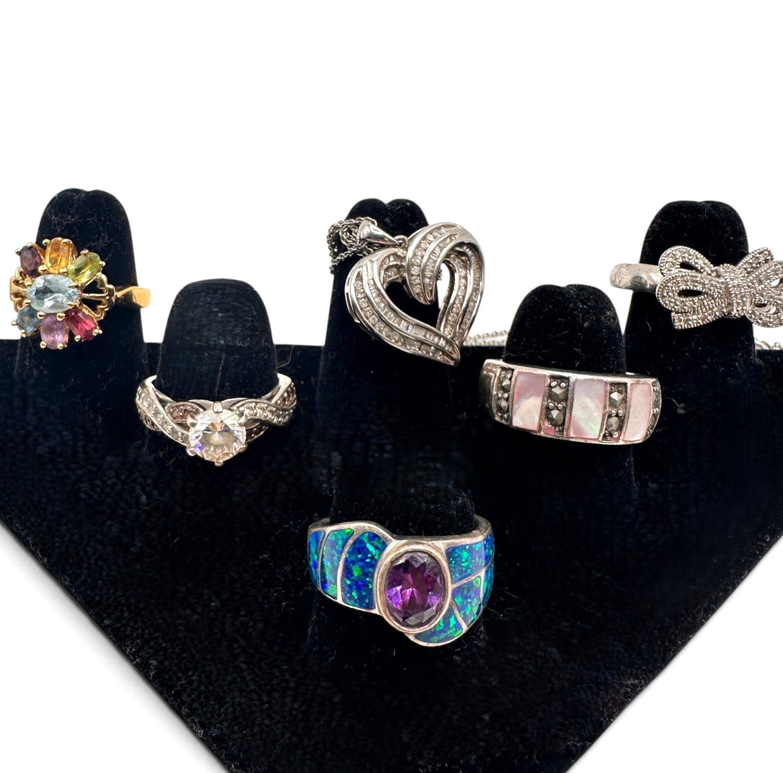 Nice Lot of 5 Sterling Silver Rings with Sterling Heart Necklace: Necklace chain measures 16" in length. See photos for individual ring sizes. Please review photos for more details as they are a part of the description. Item is being sold as found from an estate col