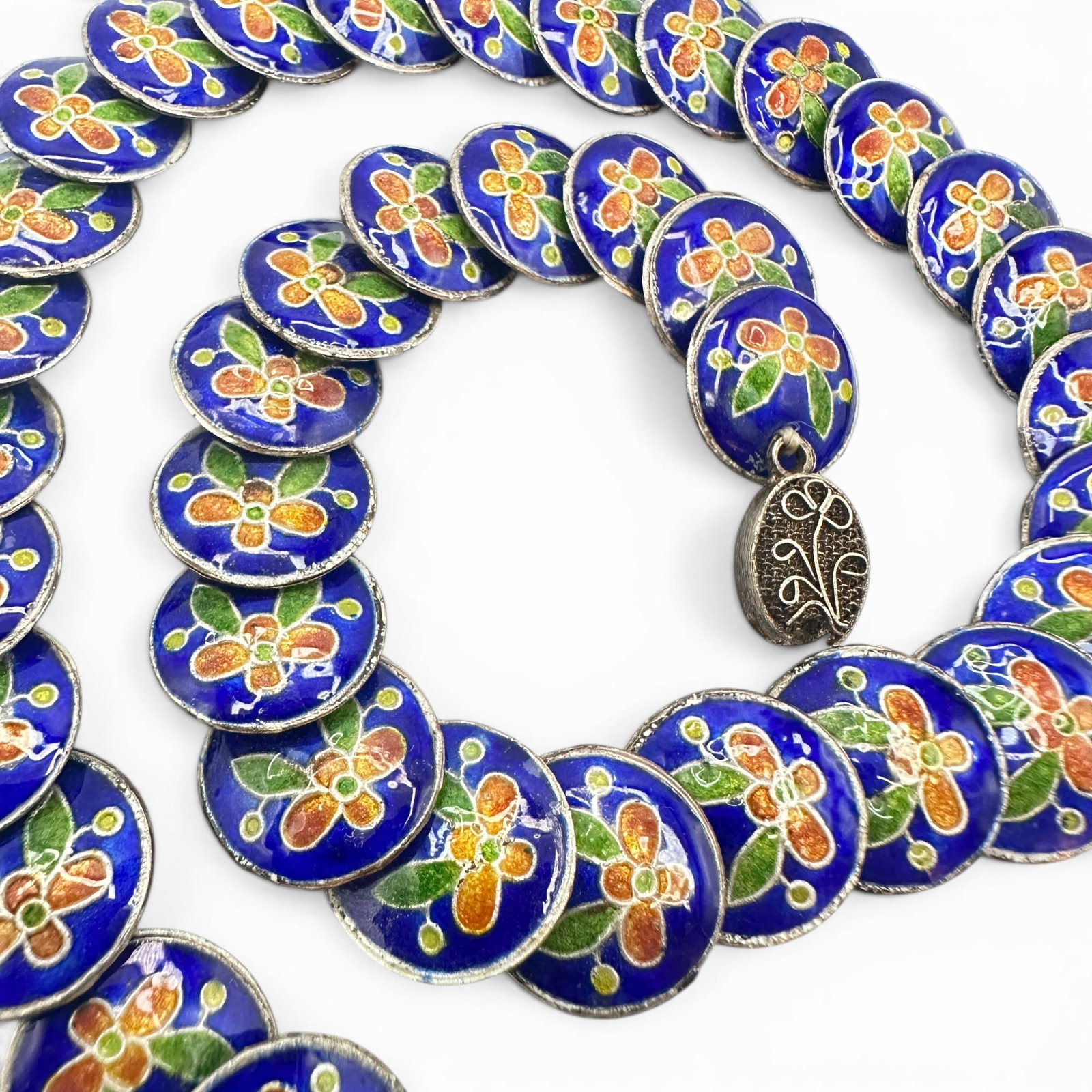 Chinese Vintage Cloisonne Enamel Necklace: Features coin shaped beads with floral designs. Measures 17" in length. Needs a new clasp. Please review photos for more details as they are a part of the description. Item is being sold as found from