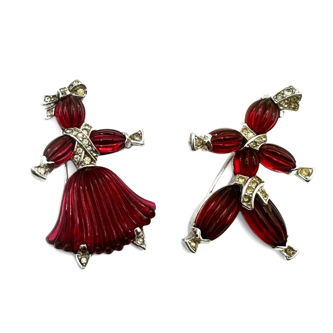 Iconic Pair of Trifari 1940's Pom-Pom and Tom-Tom Alfred Philippe Brooches: Highly collectible pair of brooches made of red molded art glass with rhinestone accents. Please review photos for more details as they are a part of the description. Item is being sold as found from 