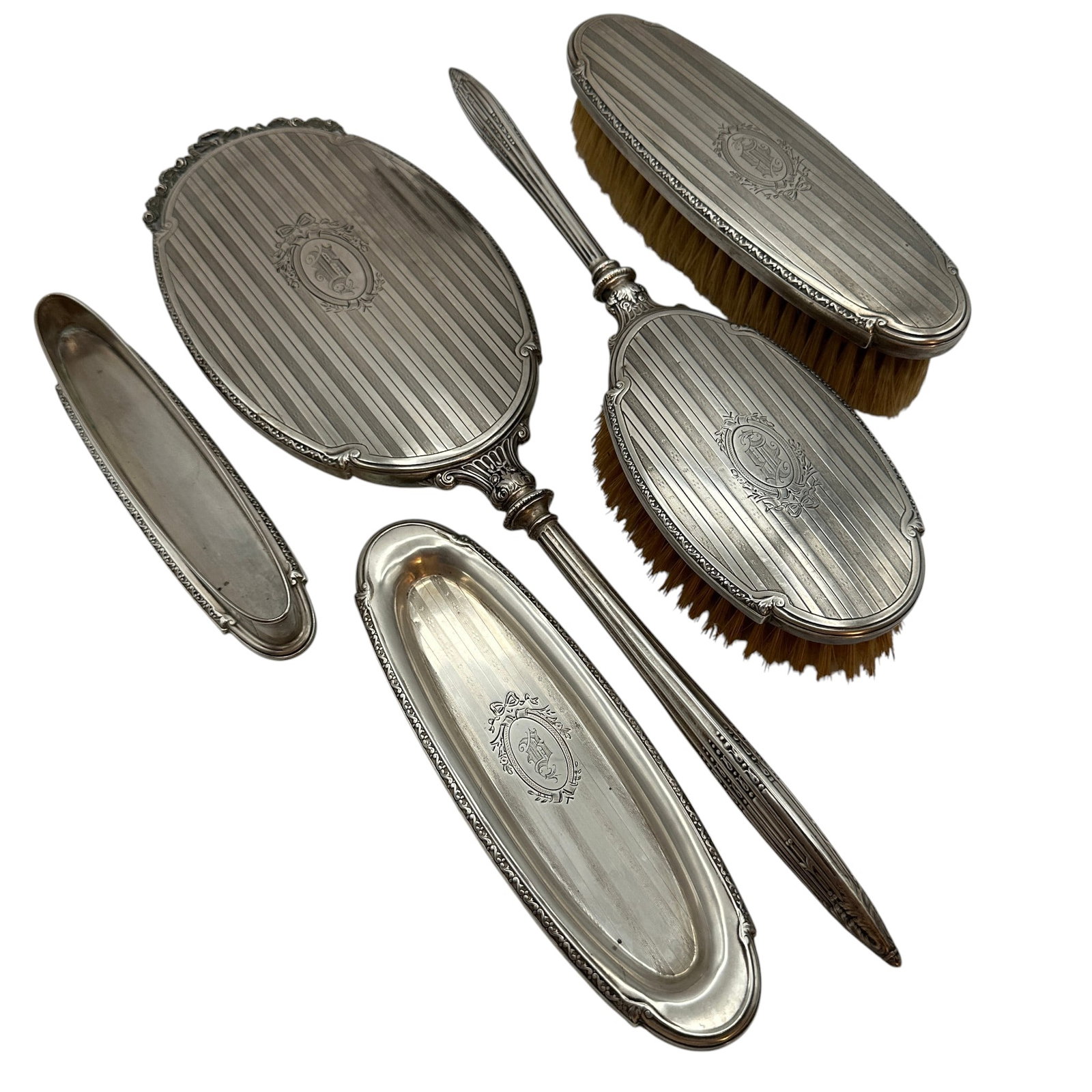 Vintage Sterling Silver Grooming Set: Oblong tray and oval container together weigh 121 grams. Brushes and mirror have not been weighed. See photos for measurements. Please review photos for more details as they are a part of the descript