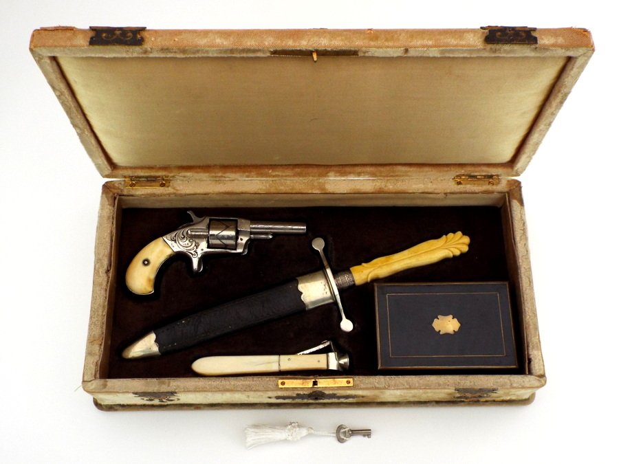 Antique Gambler Set in a White Felt Box .19th century Defender Revolver with Fine Grips and Engraved: Antique Gambler Set in a White Felt Box .19th century Defender revolver with Fine grips and engraved scrollwork designs. Dagger Very Fine Handle and Blade Marked PREFER JOHN COE SHEFFIELD. Cigar cutte