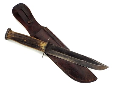 Rare WWII Western fighting knife with leather scabbard.