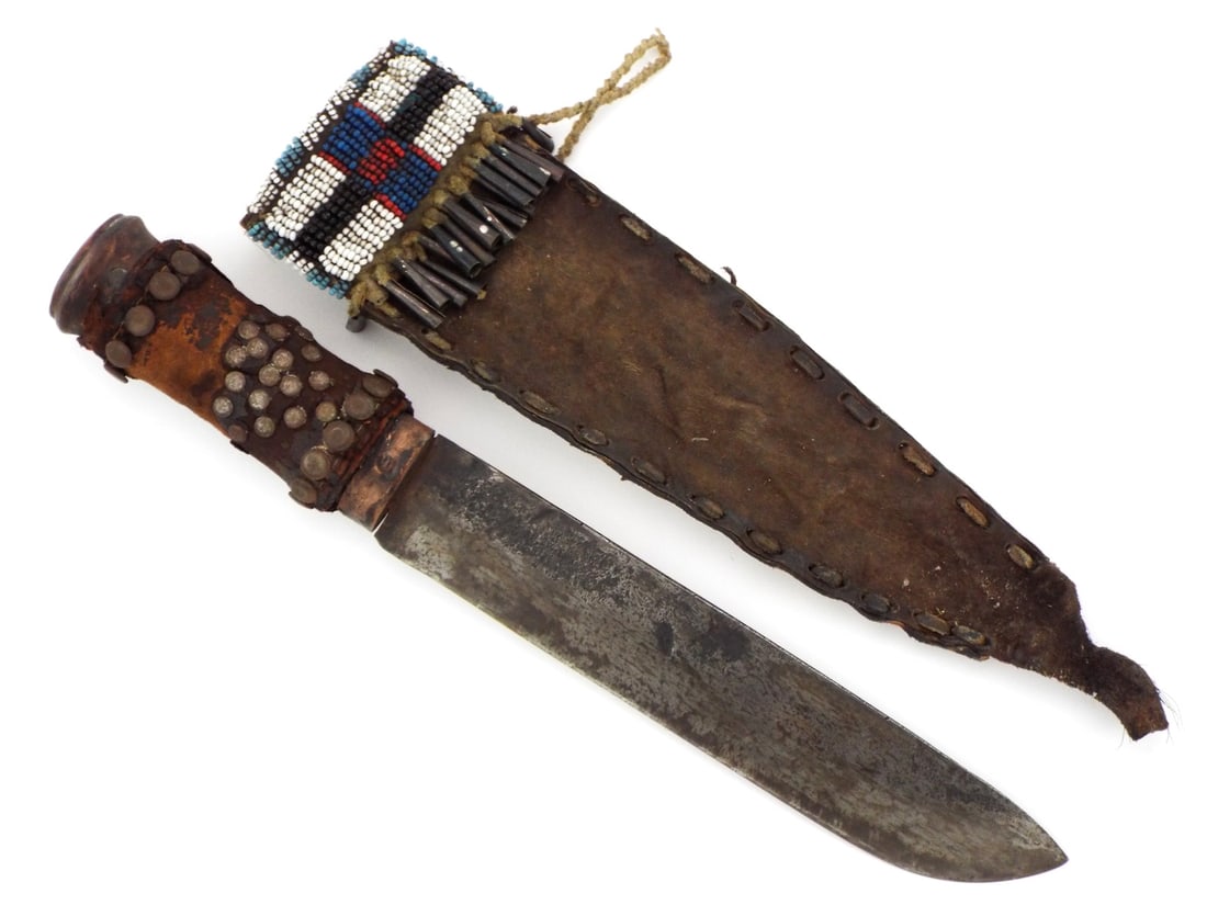 Scarce Antique Native American Indian Hand Forged Knife: Scarce Antique Native American Indian hand forged knife leather wrapped and heavily decorated with various size brass tacks Crow beaded sheath , rawhide construction, hide laced sides , sinew beaded ,