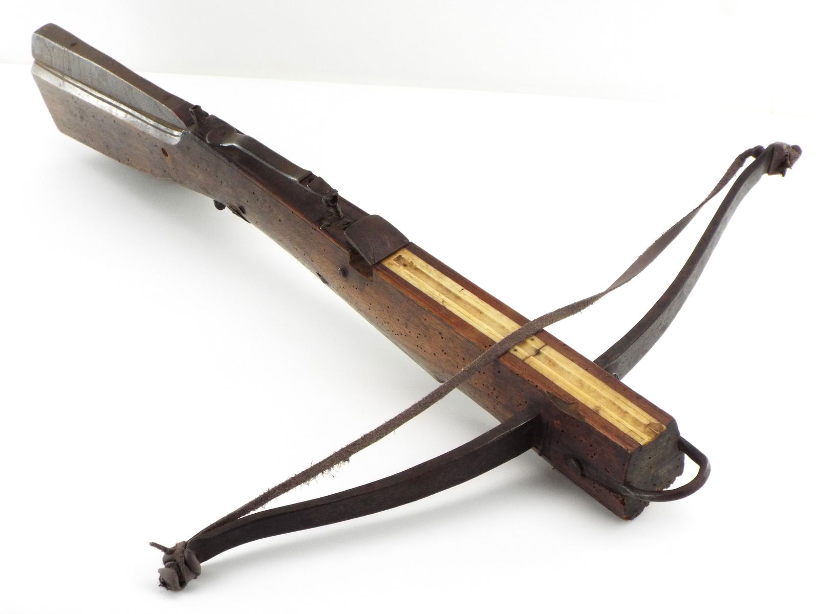 Antique 18th Century German hunting crossbow composed of a wood frame, steel bow and hardware, a: Antique 18th Century German hunting crossbow composed of a wood frame, steel bow and hardware, a bone lined channel, and carved scroll designs at one side of the wood stock. Wear consistent with age,