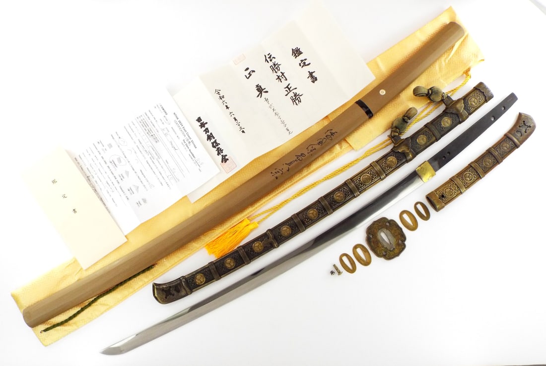 Very FINE Japanes Papered and Mounted Taisho Era Tachi & Shirasaya: This is an extremely well made, long, thick, and robust Tachi mounted sword blade attributed to the Matsamura Masakatsu Ibanagi School of swordsmithing. This blade has tightly packed straight flowing 