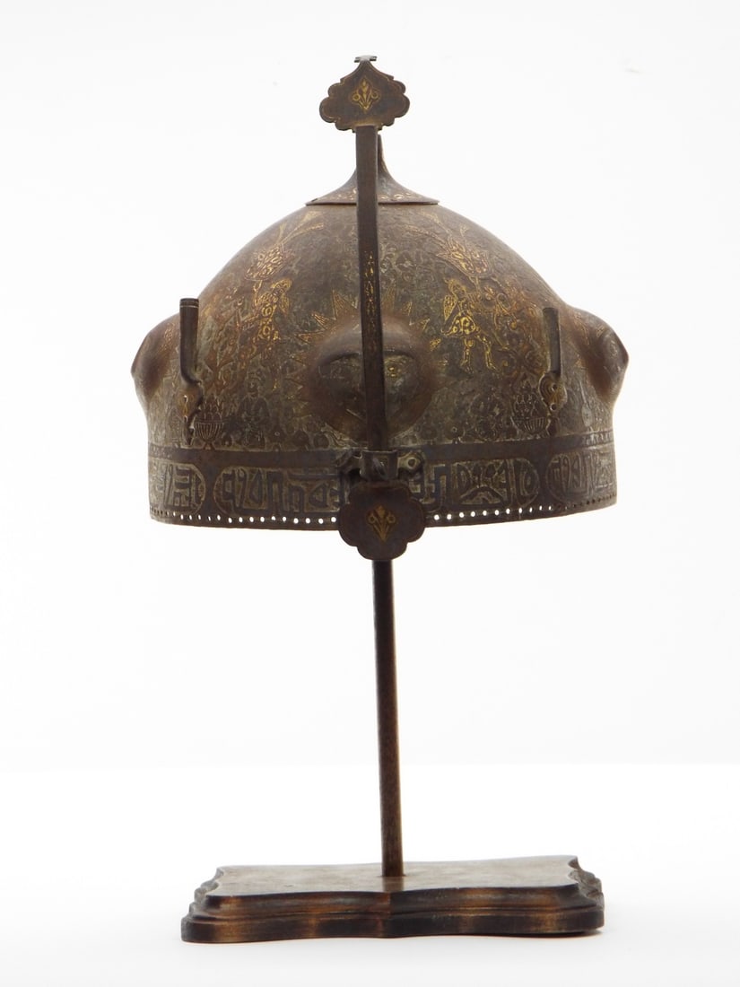 Rare Qajar Dynasty era Persian KHULA-KHUD Helmet with Gold Inlaid Decorations and Islamic Scripts.: with four raised bosses containing stylised sun faces with gold-damascened rays radiating from the centre and from each boss, with a design on an engraved floral ground, the rim with a band of inscrip