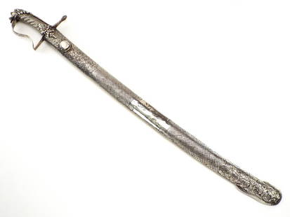 Scarce 18th C. Silver Mounted Sumatran Saber Sword: An impressive Indonesian saber that was clearly inspired by European examples introduced by the colonists. It is completely mounted in thick silver. The hilt with a very well articulated lion head pom
