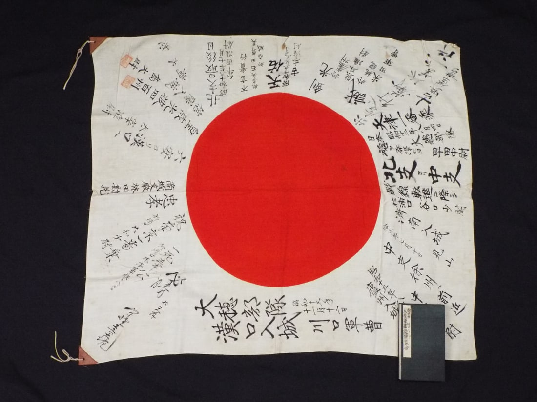 Translated WWII Imperial Japanese Army Good Luck Flag and Commemorative Booklet: Offered here are the war souvenirs brought home from WWII by a US serviceman. Although the circumstances of how they were acquired are unknown the professional translation of both items have proven th
