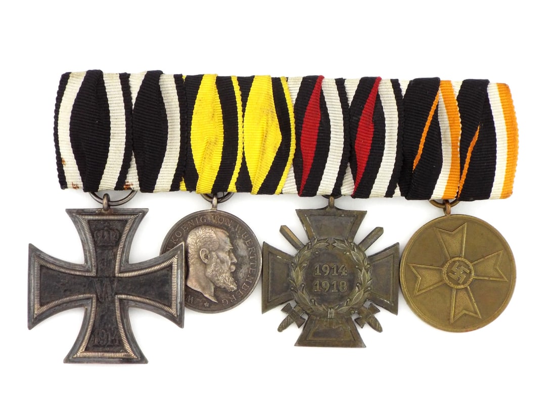 German WWI And WWII Medal Bar For Full Uniform Dress Occasions And Parade.: Bar consists of 1914 Iron Cross second class, Baden Wurttemberg Bravery medal, Hindenburg Cross for Combatants, and Nazi 1939/45 War Service medal for civilians.good condition, with original ribbons.