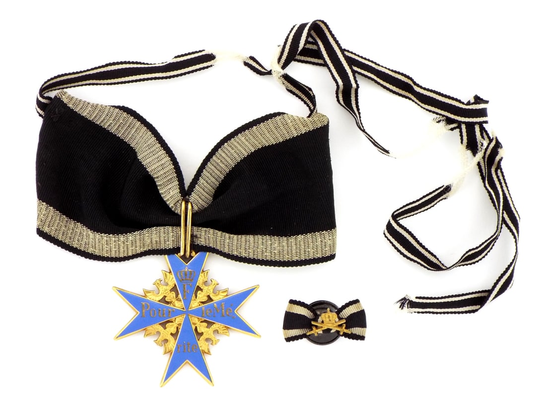 Imperial German Full Size BLUE MAX Pour Le Merite Boutonniere: This well made and desirable ribboned Pour Le' Merite, aka Blue Max, is believed to be an earlier post 1945 example of a Wagner type cross. This example has the traits of those made by the German firm