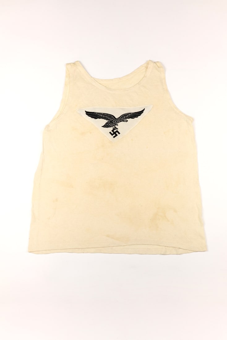 German WWII Luftwaffe M35 Sports Shirt: German WWII Luftwaffe M35 Sports Shirt.Luftwaffe embroidered insignia sewn on an original M35 sport shirt. Overall in excellent condition