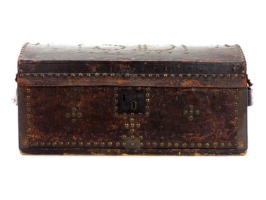 Early 1800s trunk decorated with brass tacks, initials S D on top, leather handles on sides. Hinges