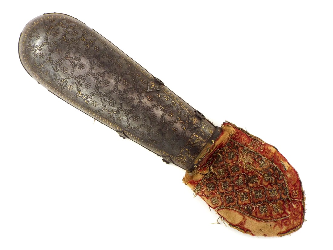 Indian BAZU BAND Gold Koftgari Silk Cushion: 18th century Indian steel bazu band arm defense. Entire surface lavishly decorated in gold koftgari with dense scrolling foliage and floral bouquets on a dark ground, crimson velvet lining and