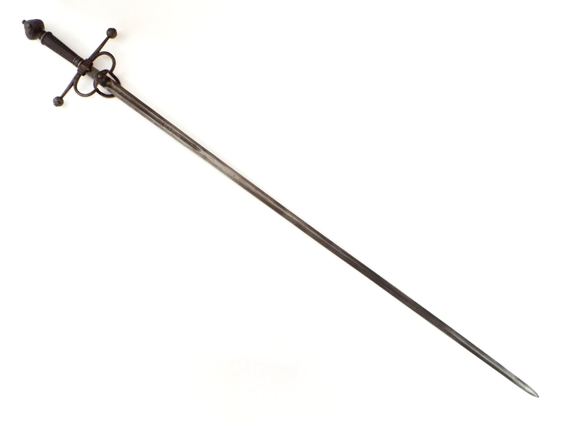 Rare German Saxon Large Transitional Swept-hilt Rapier Bastard Sword: Strong and Sturdy Maker Marked Blade Inscribed THE BAPTIST MADE ME in Latin. Elaborate Chiseled Steel Mounts and Wood Grip Inlaid with Fine Silver Nails. An Exceptionally Impressive Large Weapon of th