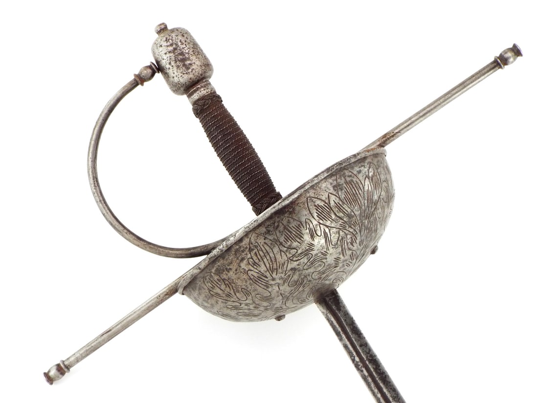 MASSIVE 17th-18th C. German CUP HILT RAPIER: 17th-18th C.German CUP HILT RAPIER with massive steel cup hilt, engraved foliage decoration on the outside, wide crossbar with long quillons and integral knuckle bow. Twisted wire wrapped grip and a
