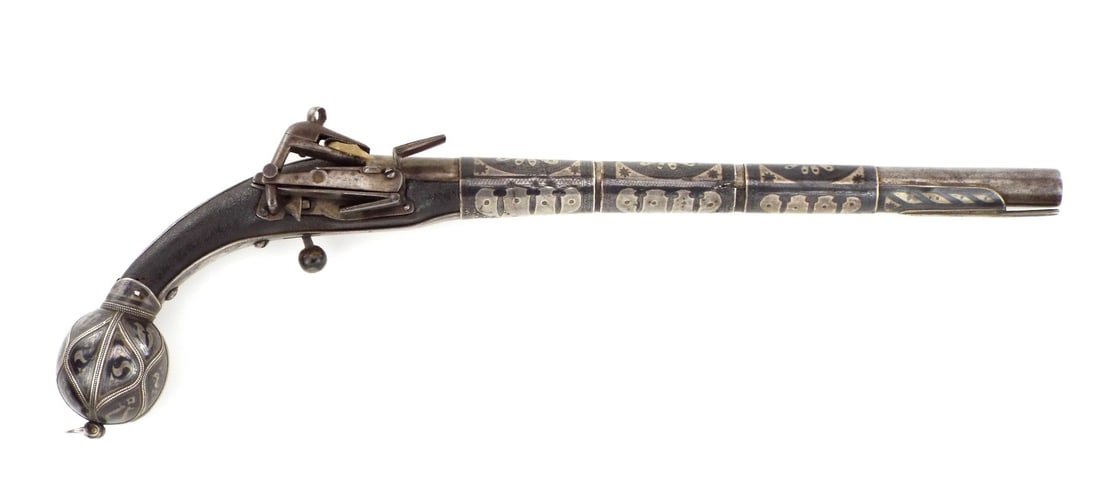18-19th C. Large Caucasian Elaborate Niello Decorated Miquelet Pistol: This highly ornate pistol was likely manufactured in the late 18th century in the Caucasus region. That region was the frontier between the Russian and Ottoman empires at the time. The decoration on t