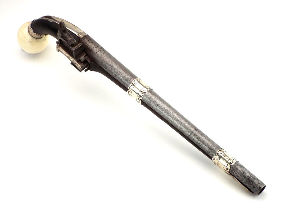 19th C. Caucasian MIQUELET PISTOL Elephant Butt Cap: 19th century Russian Caucasian full stock miquelet pistol with smoothbore barrel. Stock enriched by finely engraved silver mounts in classic Caucasian taste, terminating in a massive FINE bone ball bu