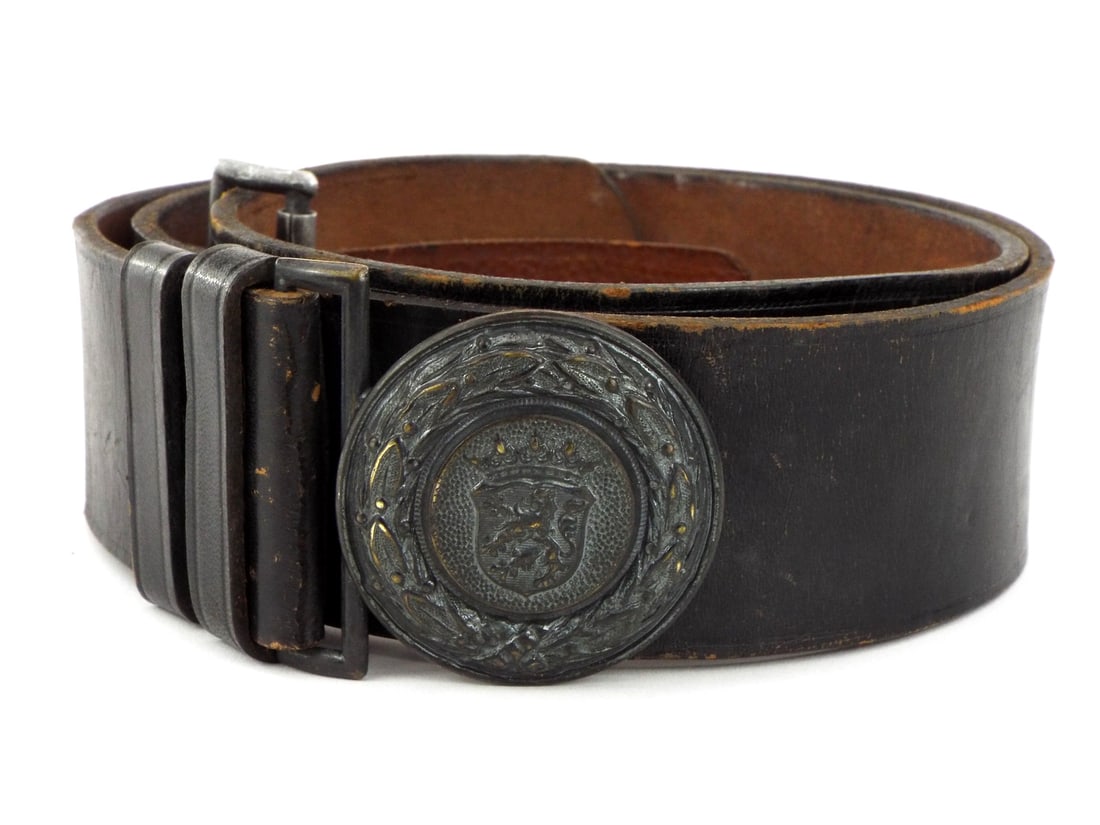 German WWII HESSEN Fire Defence Officers Belt and Buckle: German WWII Hessen Fire Defence officer's belt and buckle bearing the mark "89". Round brass buckle displays rampant lion crest within oak wreath. Black leather belt with double keepers and stitched c
