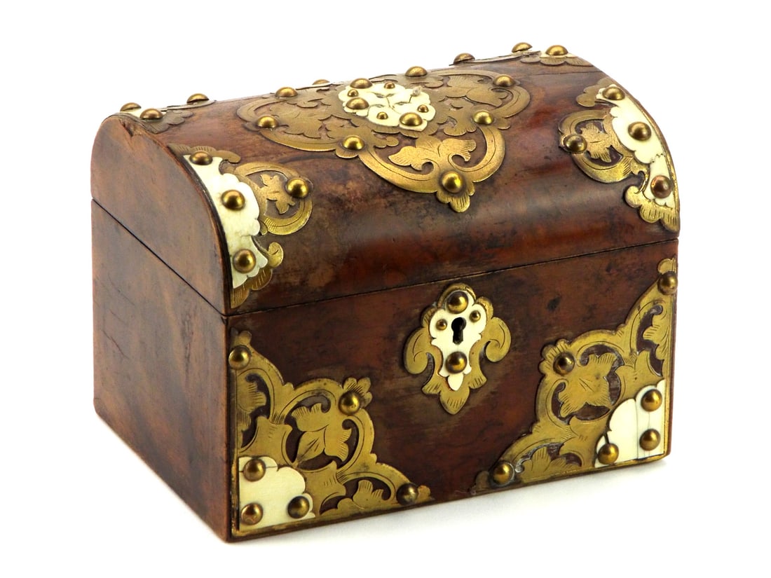 A Victorian Burr Walnut And Brass Decorative Box: Circa 1860-1880, British burr walnut decorative box. The domed lid and body crafted from richly figured burr walnut with mellowed patina. Attractive pierced brass strapwork and mounts with foliate mot