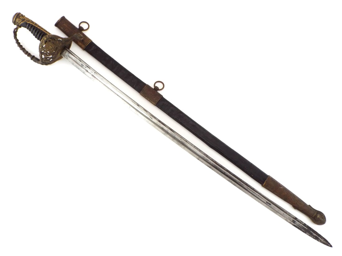 Rare 19th C. Dominican Republic Officer Sword with Leather Scabbard: Rare 19th century Dominican Republic officer’s sword. Single edged blade featuring narrow and broad fullers, surface showing light grey patina with darker areas toward the tip. Elaborate brass openw