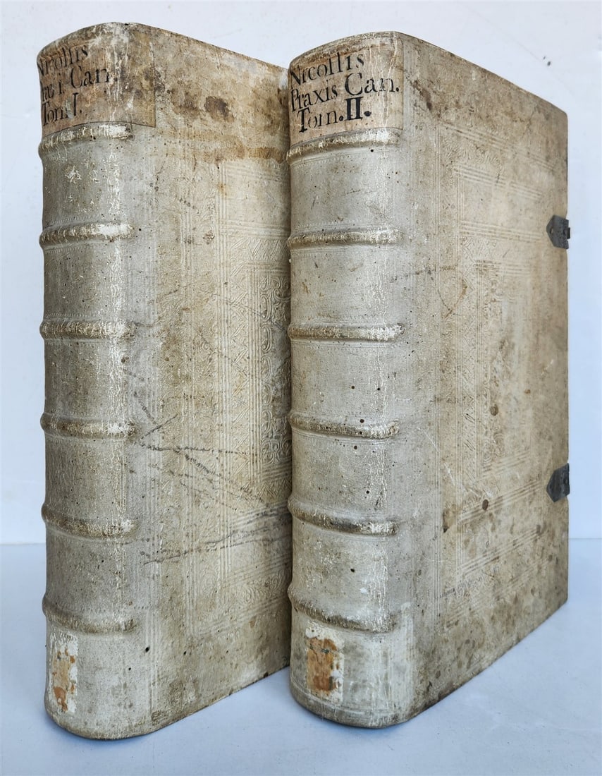 1729 CANON LAW antique 2 VOLUMES PIGSKIN BOUND FOLIO: Nicollis, L.V.de. Praxis canonica sive jus canonicum casibus practicis explanatum, constitutionibus apostolicis. cui accedit praxis romanae curiae. 2 volumes. Salzburg, Mayr; 1729. 14 leaves, 886 pp.;