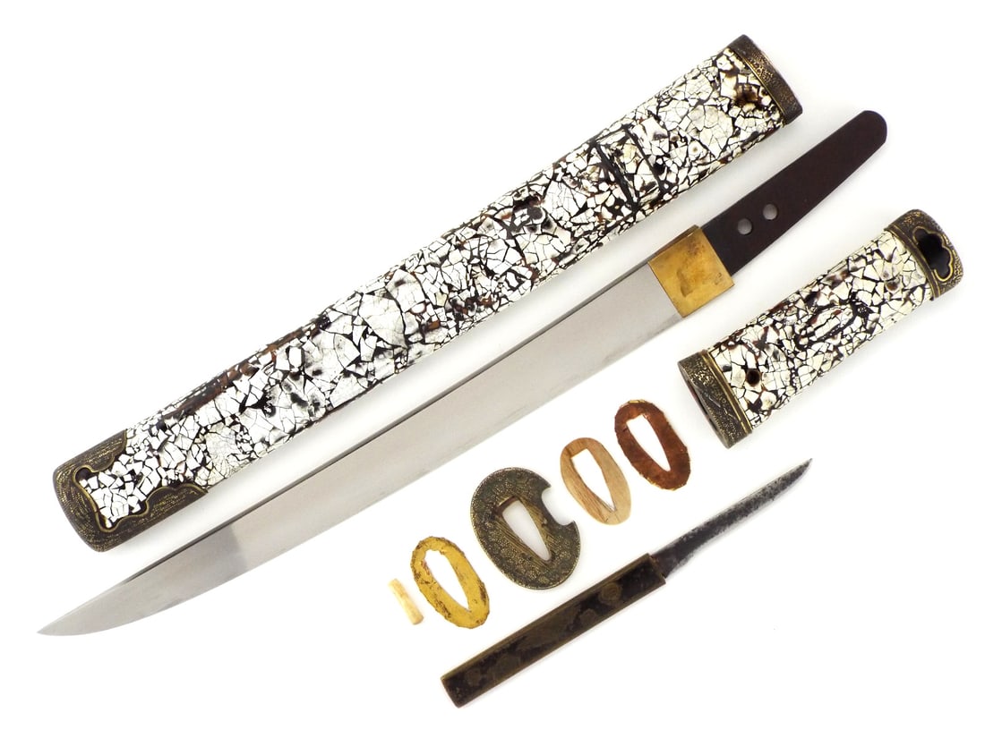 Very Good Japanese Edo Period Samurai Wakizashi: Unique Japanese tanto with a slender blade bearing distinct and beautiful hamon curves and grain marks, displays a single edged form with subtle curvature. The hilt, wrapped in striking lacquered mosa