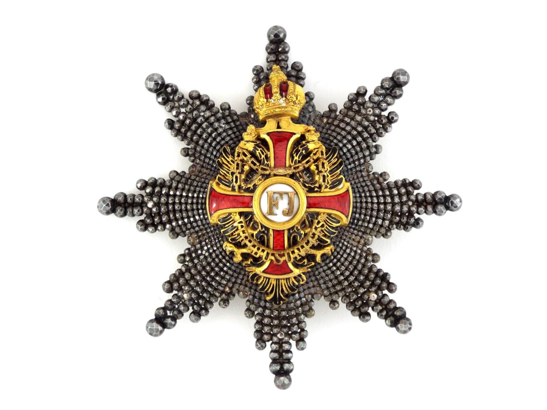Imperial Austrian Commander with Star By V. MAYER'S SOHNE Silver Enamel: Eight pointed silver star features radiant faceted rays exhibiting uncleaned patina. The body centers a superb red enameled Rupert cross with golden FJ monogram, flanked by the Imperial double eagle c