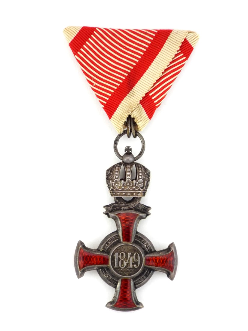 Austro-Hungarian WWI Silver Cross of Merit with Ribbon: Silver grade cross exhibits deep translucent red enamel work across the four arms, remains remarkably vibrant and displays a heavy, uncleaned charcoal patina. The central medallion features the stippl