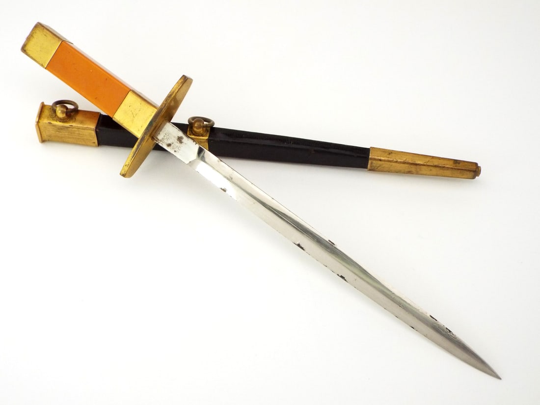 French Air Force Dagger M1934: Model 1934 French Officer's Air force Dagger. Straight double edged blade, nickel iron with a central ridge, showing honest patina and nickel peel spotting. Square brass guard and pommel. Orange bakel