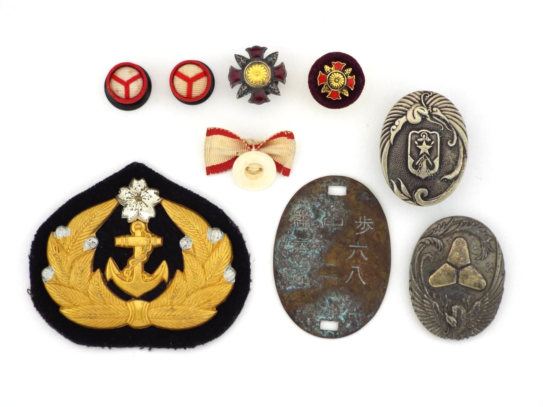 Grouping of Japanese WWII MILITARY INSIGNIA: Gold toned bullion and metal insignia shows moderate surface oxidation with intact backing, brass identification tag features heavy verdigris and legible stamp, pair of Rising Sun rosettes in good con