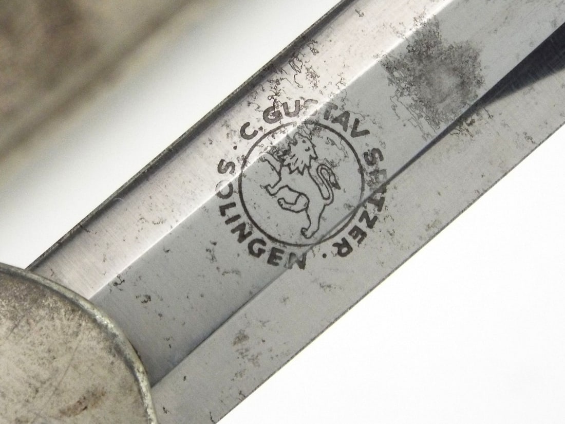 German WWII Army Officer Dagger GUSTAV SPITZER SOLINGEN & Bullion Hangers: Carl Gustav Spitzer example, the hexagonal blade exhibits a frosted maker's mark amidst honest wear and characteristic oxidation. The hilt features a crisp, right facing eagle crossguard and a white c