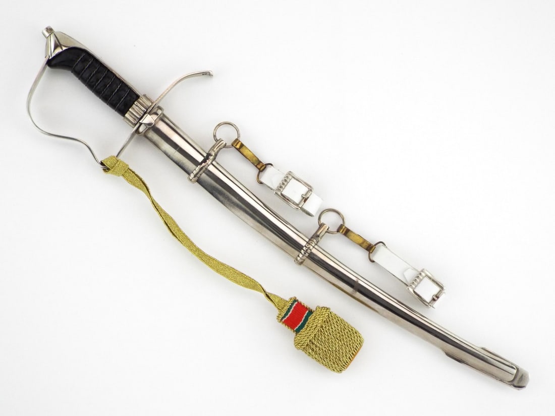 German WWII MINIATURE State Police Dress Sword with White Leather Hangers: This miniature features a nickel single edged blade exhibiting a high mirror finish and a crisp central fuller. The hilt is composed of a P-guard hilt with a classic dove head pommel and a ribbed wood