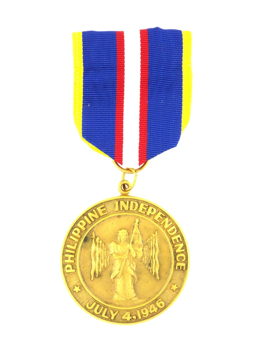 Philippine WWII Independence Medal MADE IN THE PHILIPPINES in Gilt Bronze: The planchet shows a fine golden luster with a Libertad figure standing before a radiating sunburst, featuring the circumscription Philippine Independence July 4, 1946. The reverse displays the struck