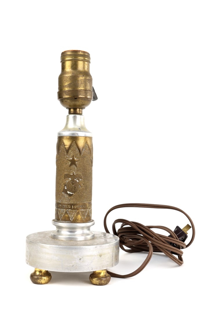 US Cold War USMC Marine Corps Lamp Stippled Brass Shell Casing: Central 40mm brass artillery casing exhibits a stippled ground featuring a raised Eagle, Globe, and Anchor emblem with "UNITED STATES MARINE CORPS" inscription and a reverse depiction of the U.S. Capi