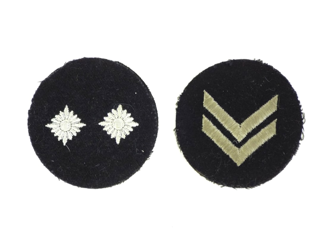 German WWII HJ RANK PATCHES RZM A4/18 Silver Embroidery: Circular black wool foundations exhibit honest nap wear and minor edge fraying consistent with field use. The Oberkameradschaftsfuhrer patch features two silver grey embroidered pips, while the Ober R