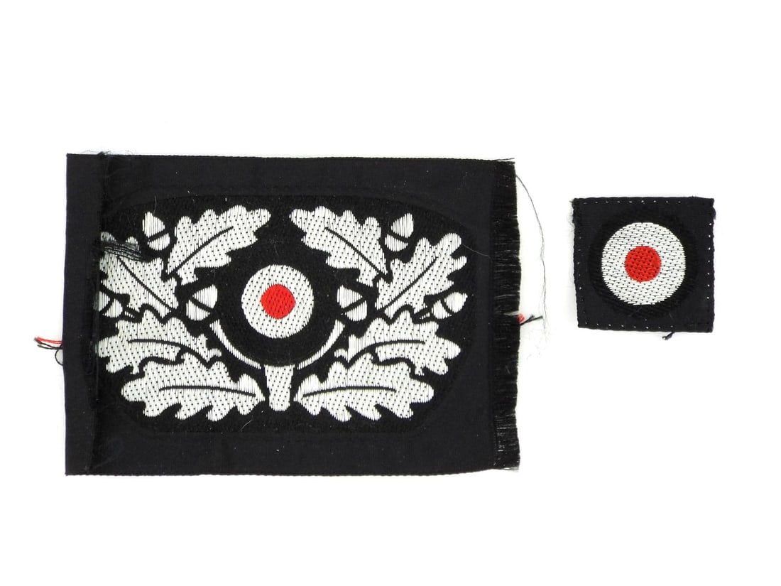 German WWII PANZER BERET INSIGNIA Set Bevo Silver Cellon: Machine woven insignia displays a tight BeVo weave construction on a deep black rayon ground, featuring the distinctive oak leaf wreath with integrated acorns and a separate national cockade. The silv