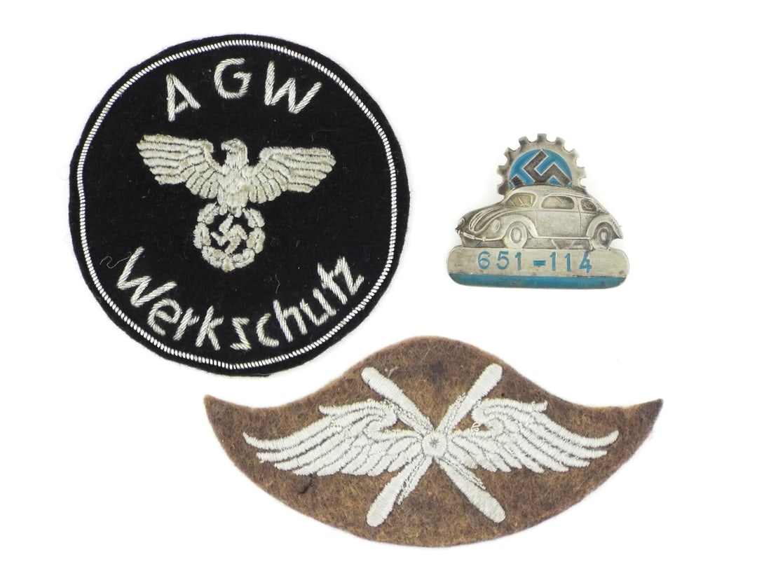 Lot of German WWII Trade Patches AGW WERKSCHUTZ & VOLKSWAGEN ID: The AGW Werkschutz circular patch exhibits fine silver bullion embroidery on a black wool ground, displaying the national eagle and wreathed ensign above the inscription Werkschutz which translates to