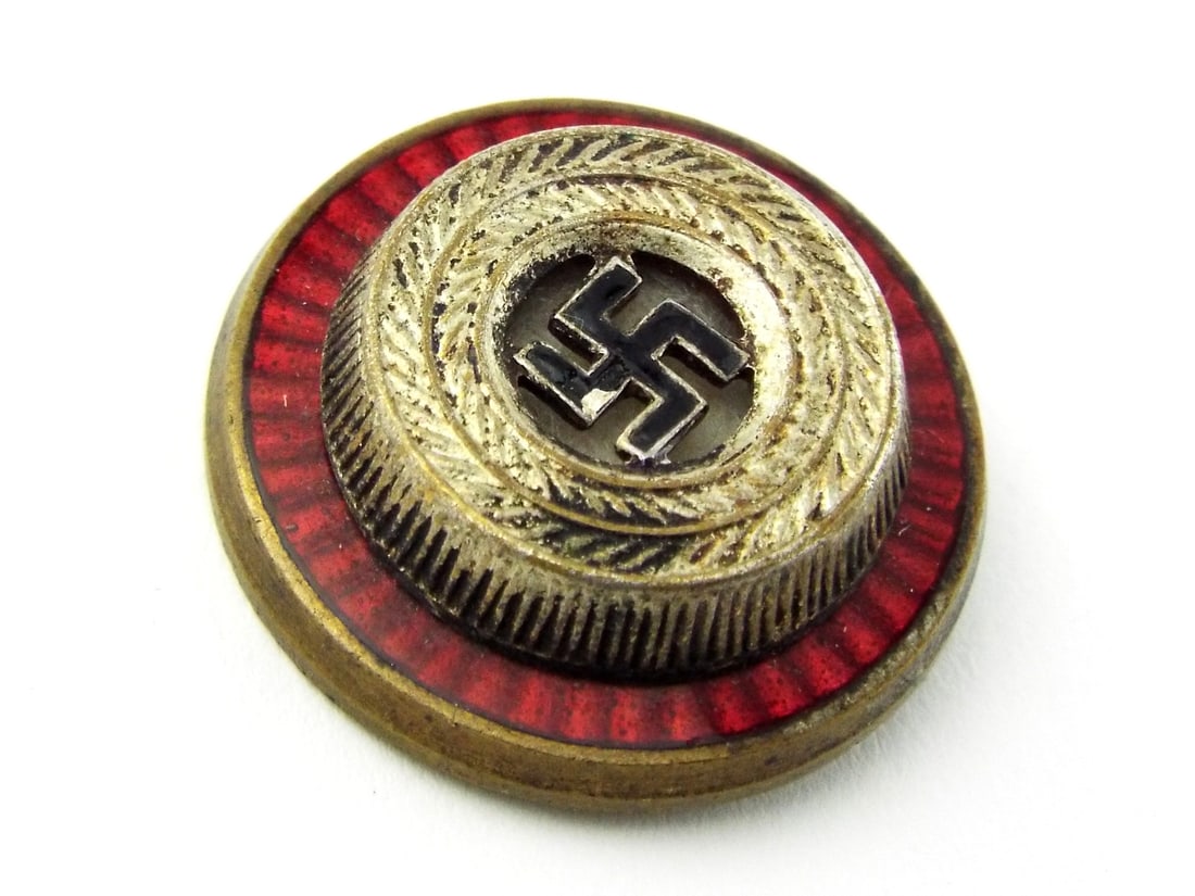 German WWII NSDAP Political Leader VISOR CAP COCKADE: Multi piece body, gilt finish exhibits typical toning and localized oxidation to the reverse. Solid double prong brass attachments remain intact for cap mounting. Marked with circular RZM logo and man