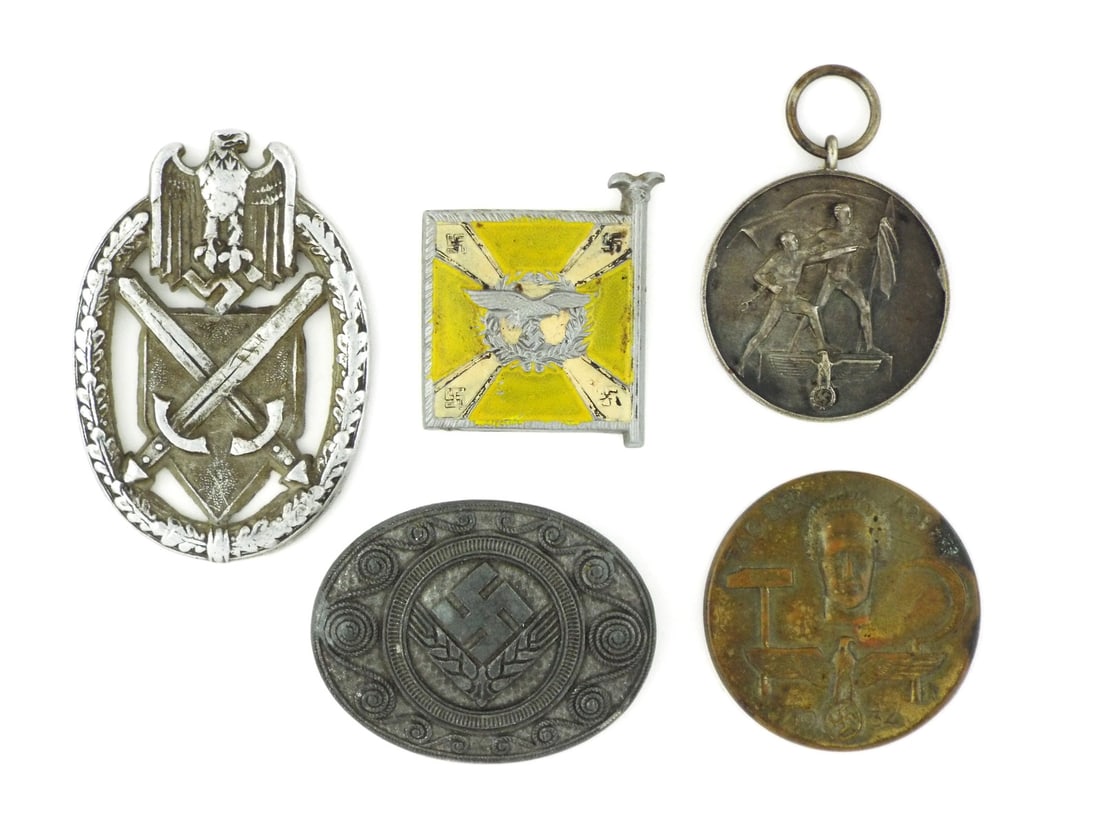 Lot of German WWII MISCELLANEOUS BADGES & TINNIES: Infantry Marksmanship Lanyard Shield exhibits loss of silver wash with three reverse prongs missing, square Luftwaffe tinnie shows only light yellow enamel loss. Austria annexation medal retains dark